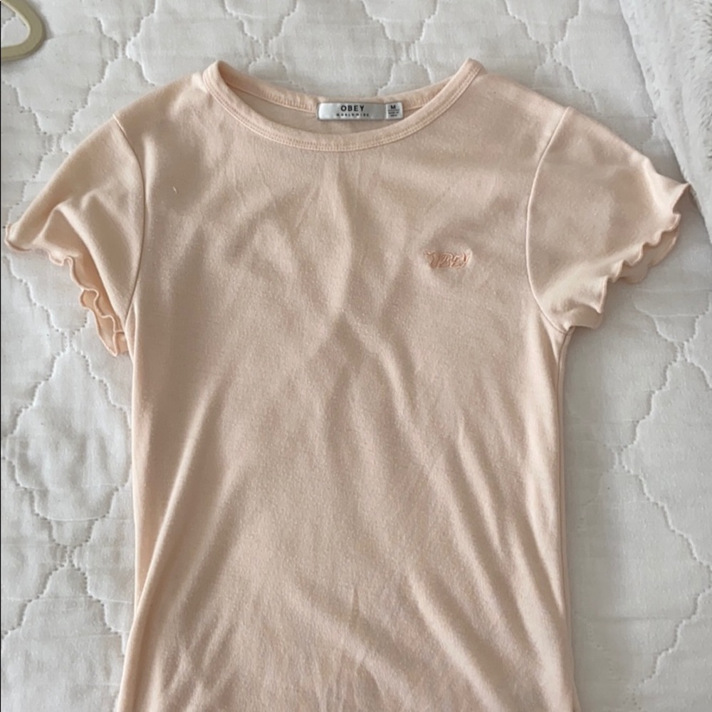 An peach obey shirt